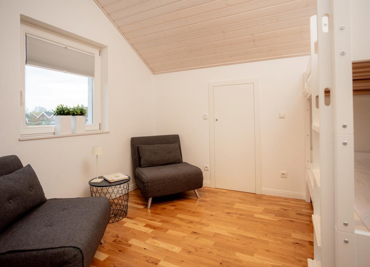 Viel Platz & Flexibilität – helles Familienzimmer mit zwei Schlafsesseln und einem Etagenbett